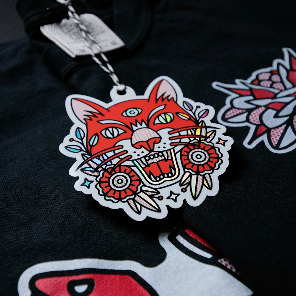 Custom hang tag with a red tiger attached to a shirt.