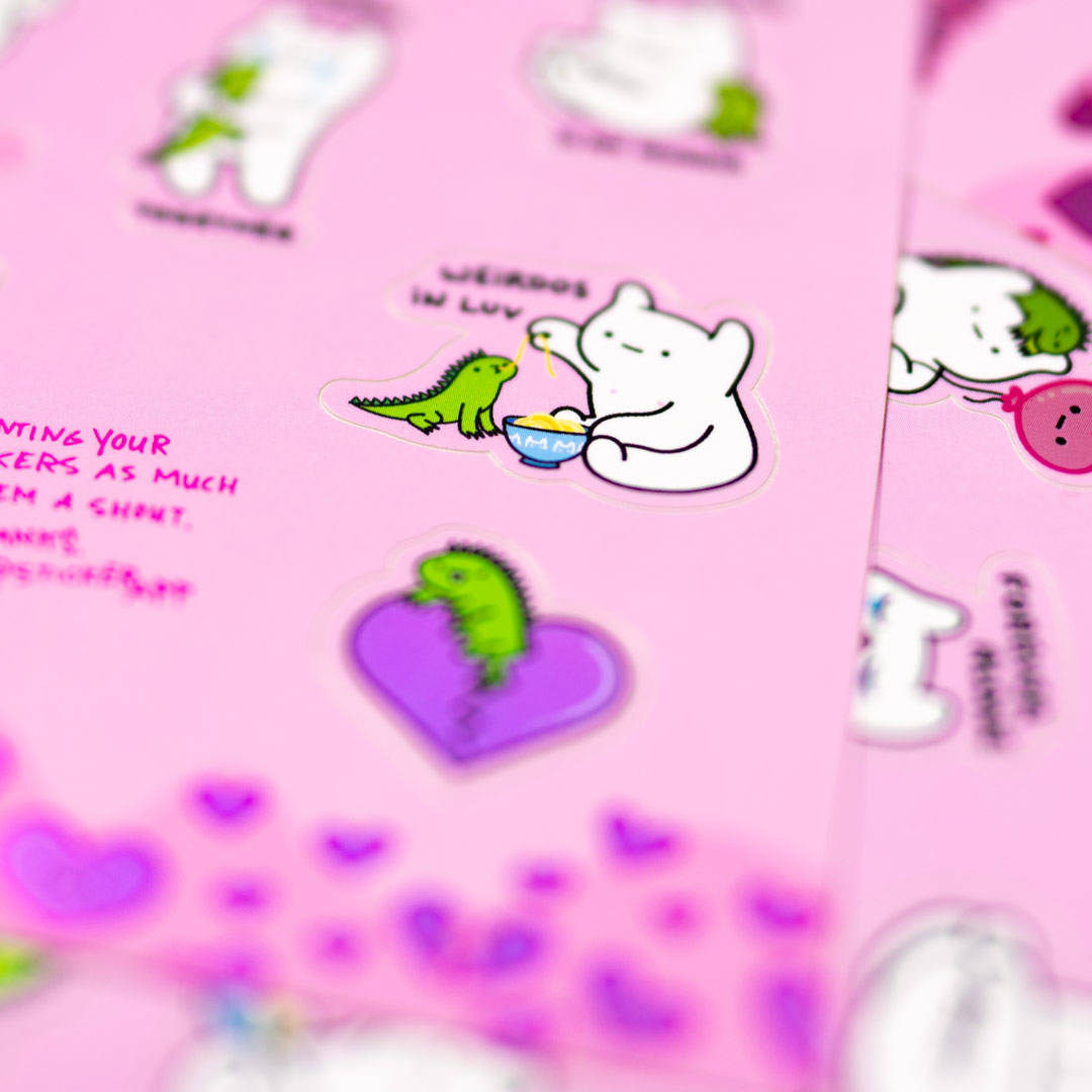 Close up on a sticker sheet, with the text "weirdos in luv"