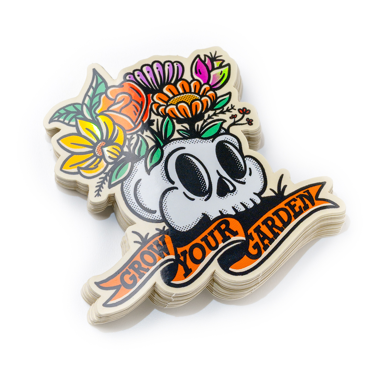 Die cut Sticker of a skull with colorful flowers on top and a banner below reading "Grow Your Garden."