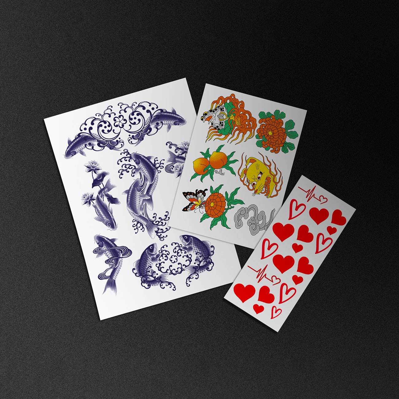 Three temporary tattoo sheets featuring different designs, including koi fish, colorful illustrations, and red hearts, laid out on a dark surface.