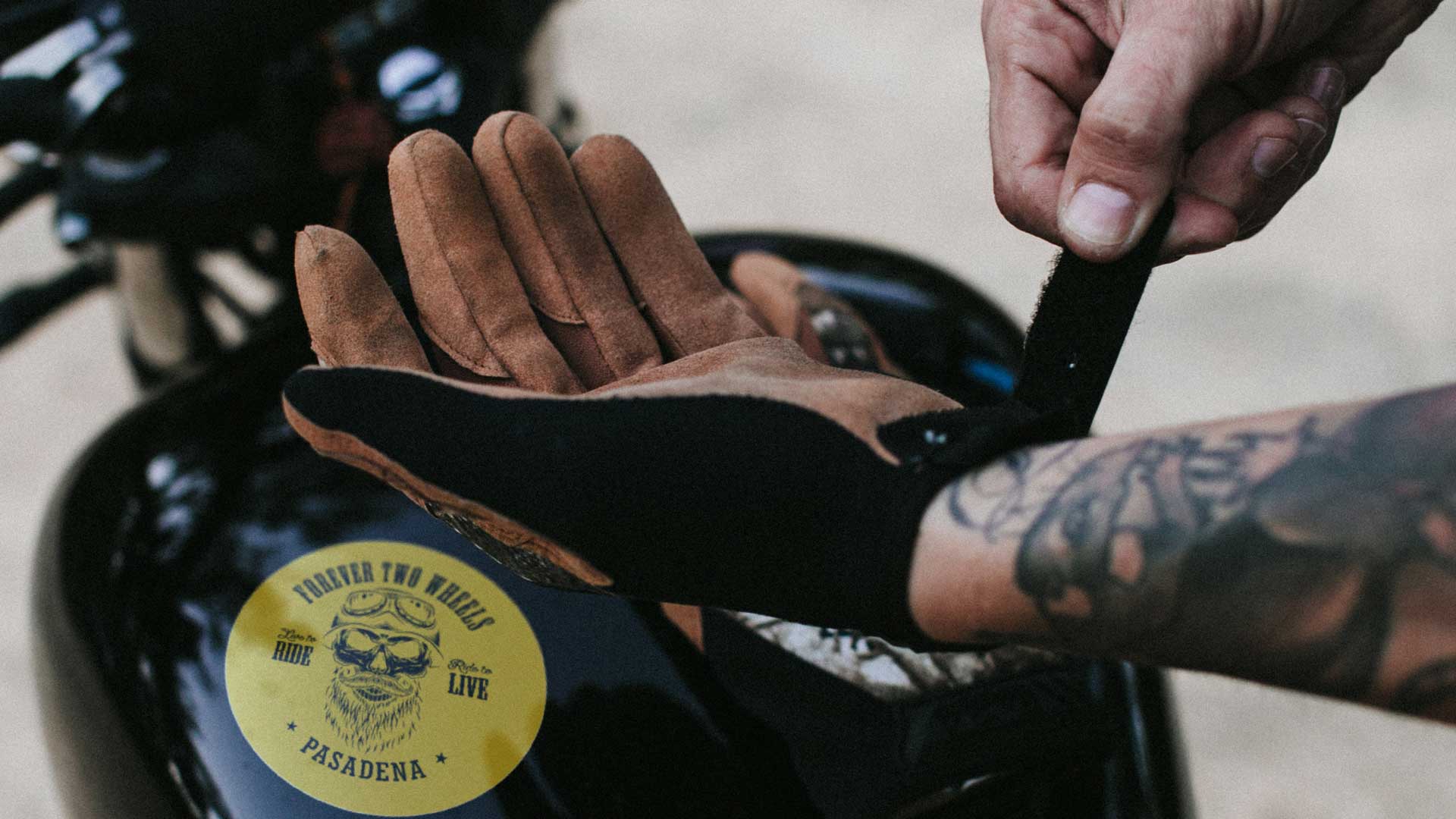 Custom made bike stickers, and a man putting on a glove.