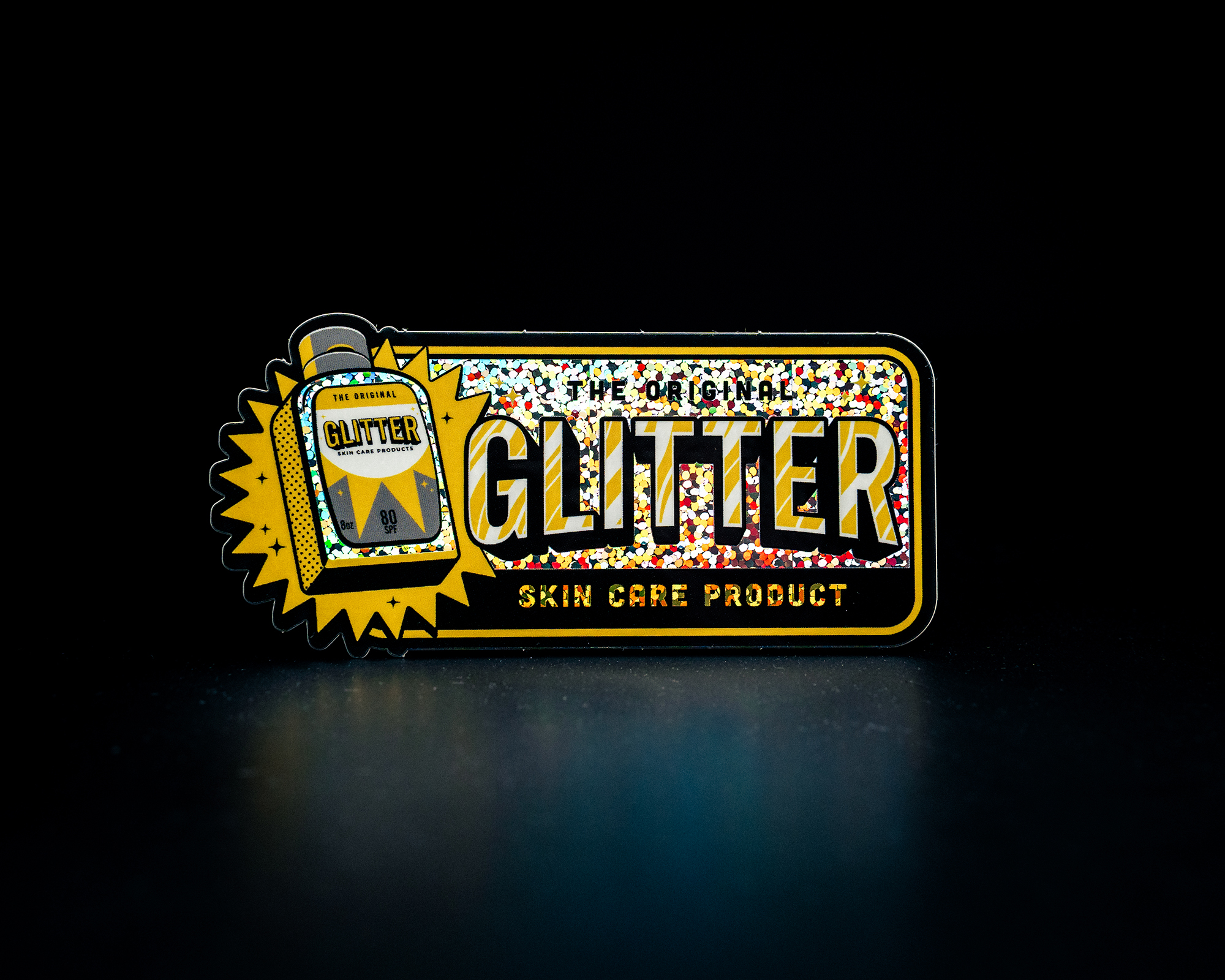 Sticker for "The Original Glitter Skin Care Product" with holographic design and bold text on a dark background.