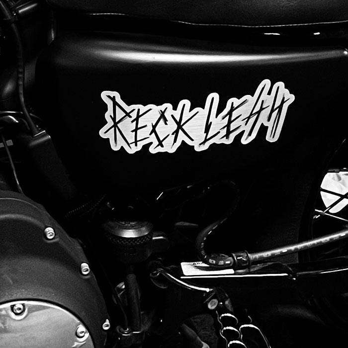 A Reckless custom sticker on a motorbike.